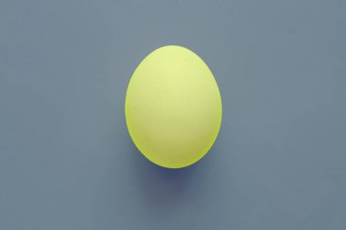 Yellow easter egg on blue background clipart