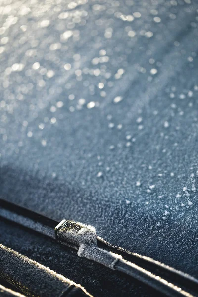 frozen windshield and wiper of car in the morning