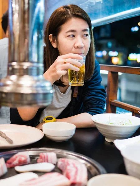 Woman eating Korean style pork BBQ
