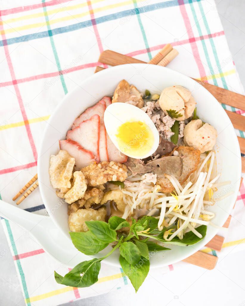 Pork rice noodle soup with meat ball, egg and vegetable