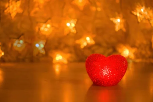 red luminous heart on a gold background with blur background. a photograph may be a layout for a postcard. Golden hearts 3d digital texture. New year background. 3D rendering