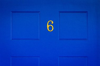Londra, İngiltere 'de kraliyet mavi ahşap ön kapısında 6 numaralı ev.