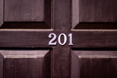 201 numaralı ev siyah ahşap ön kapıda.