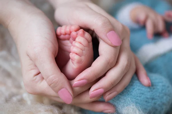 Small feet in mom\'s hands