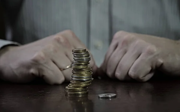 office worker sits at a table with money