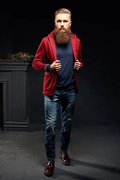 Young model man with long beard posing in dark studio — Stock Photo, Image