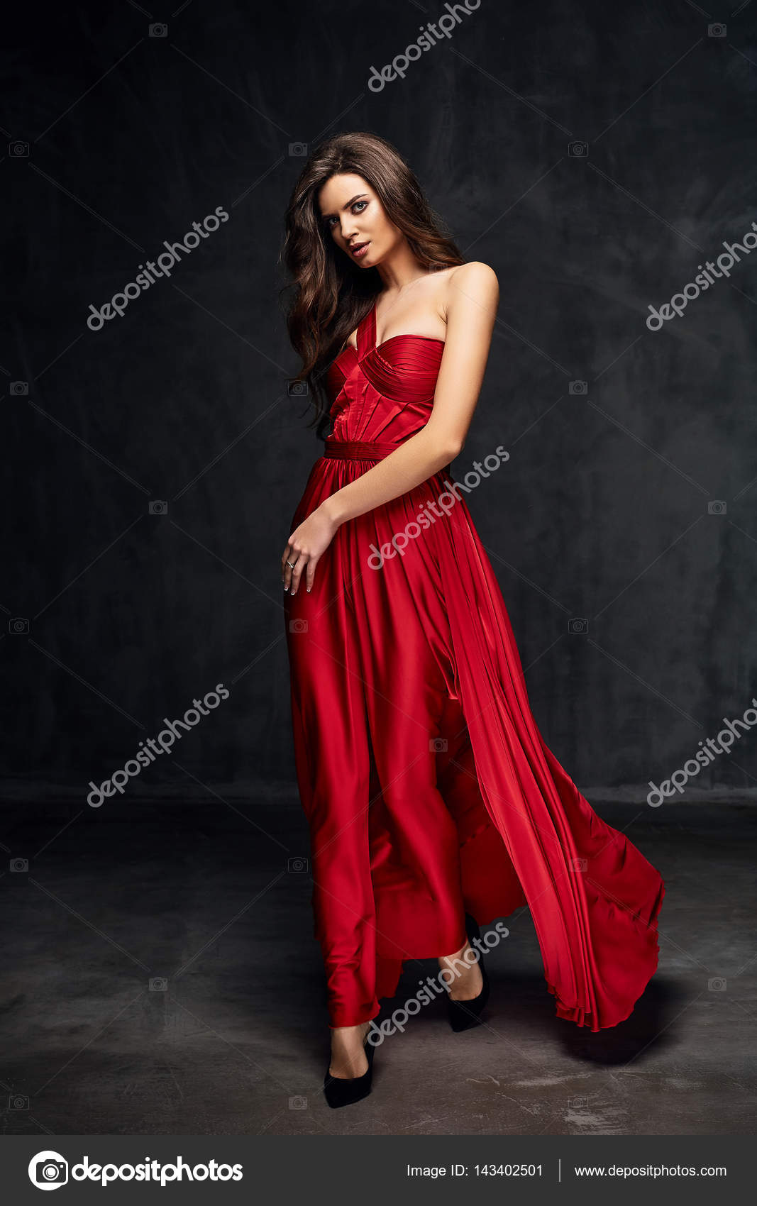 Pretty young sexy model female with dark hair in amazing long red dress ...
