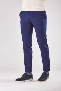 Adam trendy koyu mavi chinos ve siyah ayakkabılar Işık Studio poz