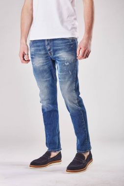 Man is posing in light studio in trendy blue denim jeans pants and black shoes clipart
