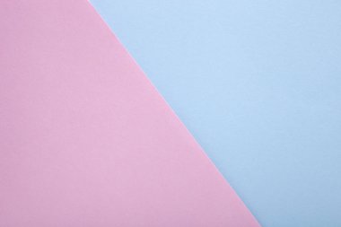 Arka plan olarak pembe ve mavi pastel kağıt dokusu. Üst görünüm