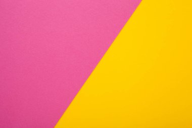 Arka plan olarak pembe ve sarı kağıt. İki renkli parlak kağıt dokusu, metin için yeri olan üst görünüm