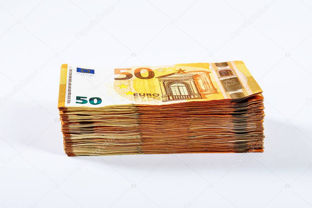 Stacks of euro banknotes on a white background in fifty euro