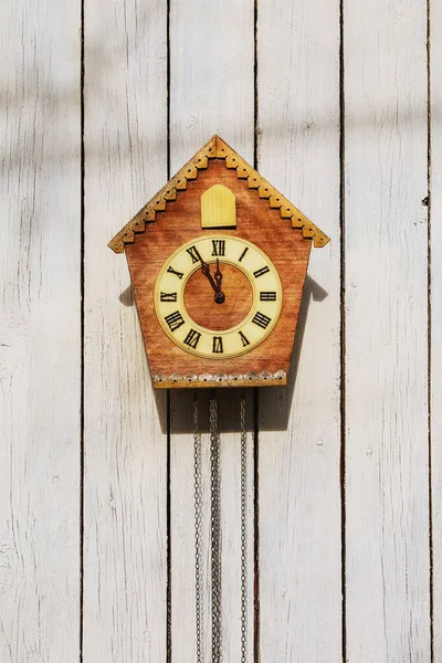 Old clock on a wooden light wall. Vintage clock. — Stock Photo, Image
