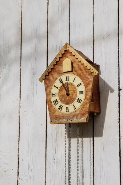 Old clock on a wooden light wall. Vintage clock. — Stock Photo, Image