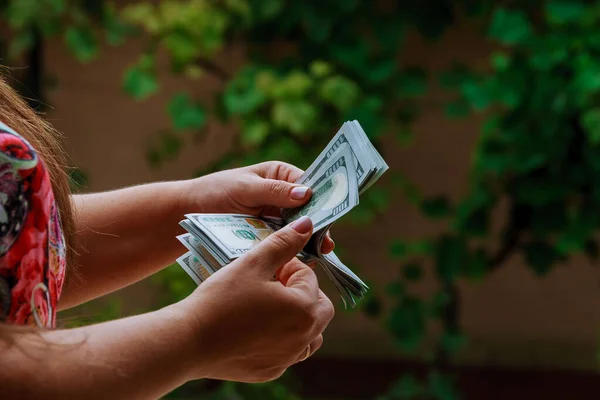 Woman hands counting us dollar banknotes. Counting or spend money.