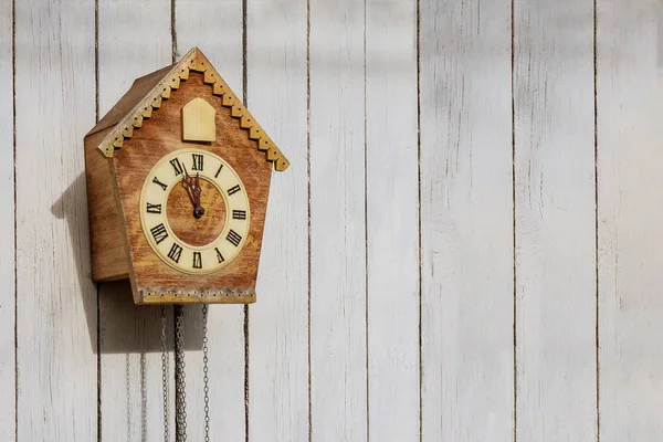 Old clock on a wooden light wall. Vintage clock. Cuckoo clock. Copy-space. — Stock Photo, Image