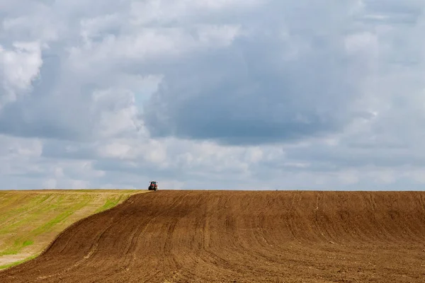 Farmer on a tractor plows the land before sowing with a seedbed cultivator — 스톡 사진