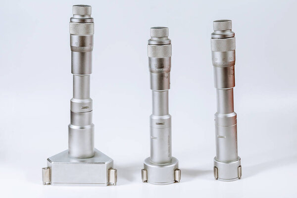 Set of calibration micrometers. Device for accurately measuring the diameter of the hole, on a white background.
