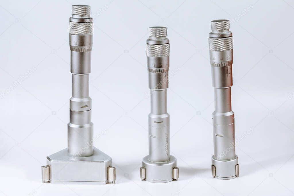 Set of calibration micrometers. Device for accurately measuring the diameter of the hole, on a white background.