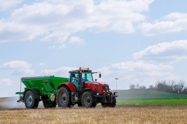 Tarım işi. Traktör çimlere gübre yayıyor..