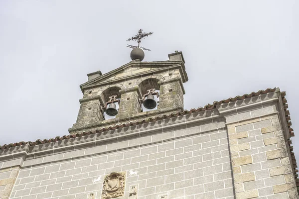 Bell tower of a church with a cross and weather vane above and d — Stock Photo, Image