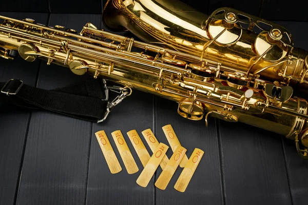 Reeds of mouth piece of a saxophone with a tenor saxophone on gr