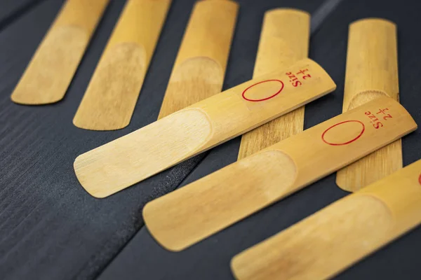 Reeds for a mouthpiece of a wooden instrument on gray wooden bac — Stock Photo, Image