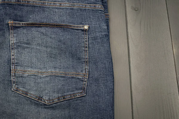Back pocket of a washed blue denim pants — Stock Photo, Image