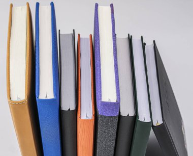 Top view of the sheets of several books and their spine in diffe