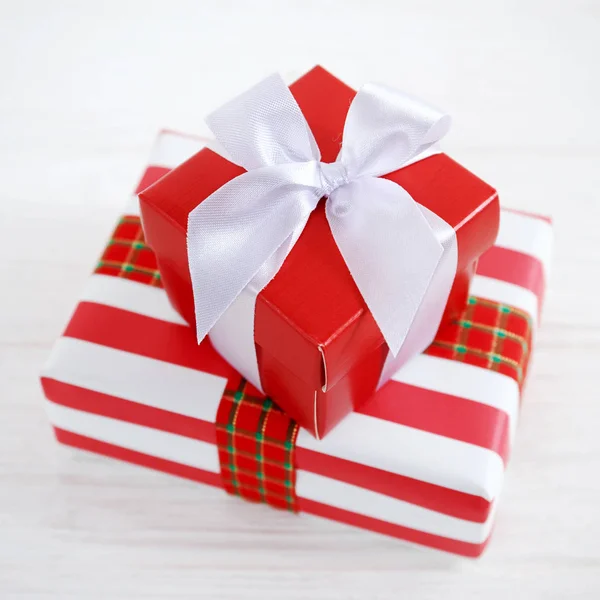 Red gift box with white ribbons — Stock Photo, Image