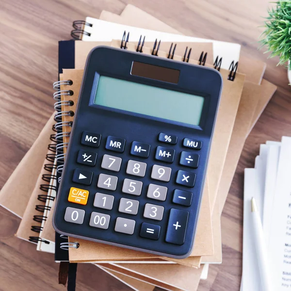 Calculator on notebook — Stock Photo, Image