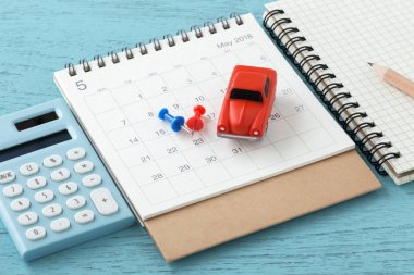 Hesap makinesi ile takvim üzerinde oyuncak araba 