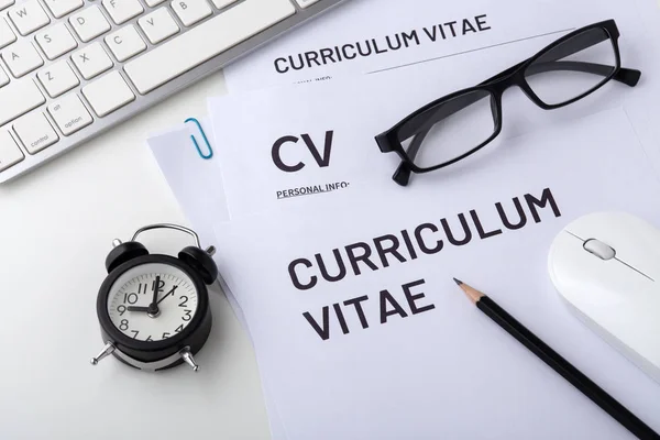 Job interview with cv, clock on white desk