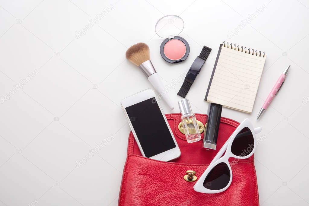 Red woman bag with cosmetic, sunglasses and accessories