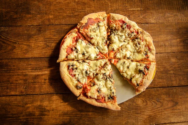 Pizza Gotowana Domu Jest Pokrojona Kawałki Leży Drewnianym Stole — Zdjęcie stockowe