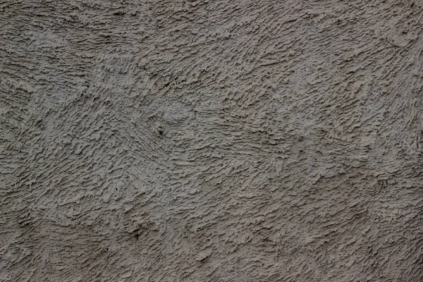 Tekstura szara tynkowana ściana na tle. Twardy tynk cementowy. Fasadowe tło sztukaterii. Na zewnątrz budynku. Tynk cementowo-cementowy — Zdjęcie stockowe