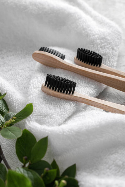 Several bamboo toothbrushes on a white towel. Close up. The concept of beauty and health about yourself. Zero West