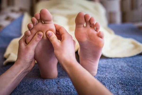 foot massage reflexology therapy in saloon
