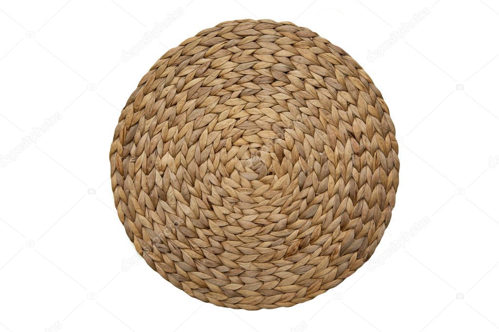 Round woven straw mat isolated
