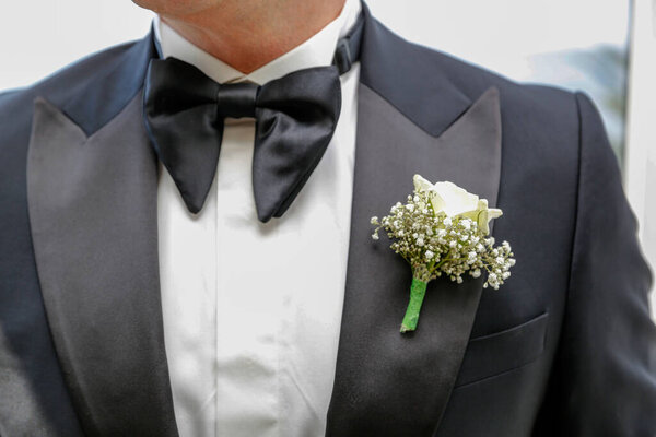 small boutonniere to a jacket