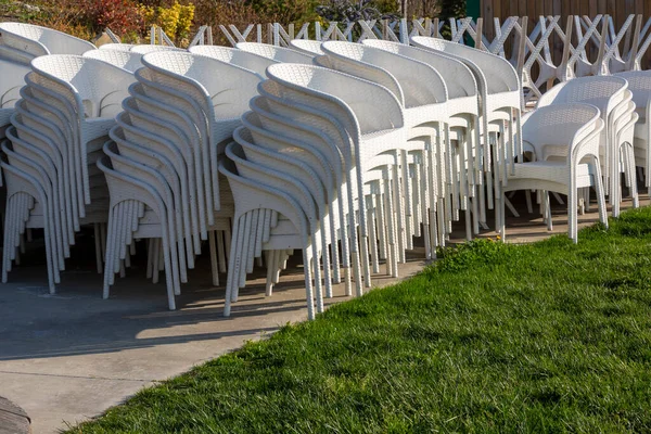 clouse-up white garden chairs on park
