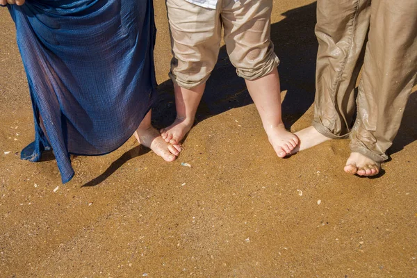 wet feet standing on sand