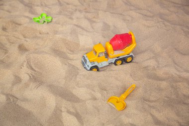 Kumda parlak plastik çocuk oyuncakları. Çocuklar için plaj eğlencesi kavramı. Üst görünüm