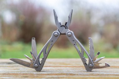 Useful multi-tool gadgets as helpful outdoor equipment for adventurers and survival experts or just camping in the wilderness with the kids and a young outdoorsman perfect with a foldable pocket knife