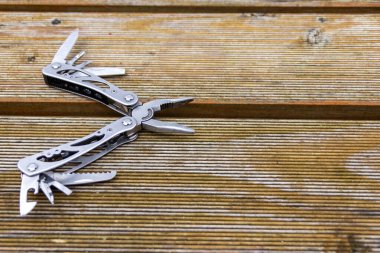 Useful multi-tool gadgets as helpful outdoor equipment for adventurers and survival experts or just camping in the wilderness with the kids and a young outdoorsman perfect with a foldable pocket knife