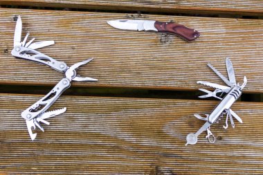 Useful multi-tool gadgets as helpful outdoor equipment for adventurers and survival experts or just camping in the wilderness with the kids and a young outdoorsman perfect with a foldable pocket knife