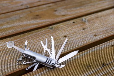 Useful multi-tool gadgets as helpful outdoor equipment for adventurers and survival experts or just camping in the wilderness with the kids and a young outdoorsman perfect with a foldable pocket knife clipart