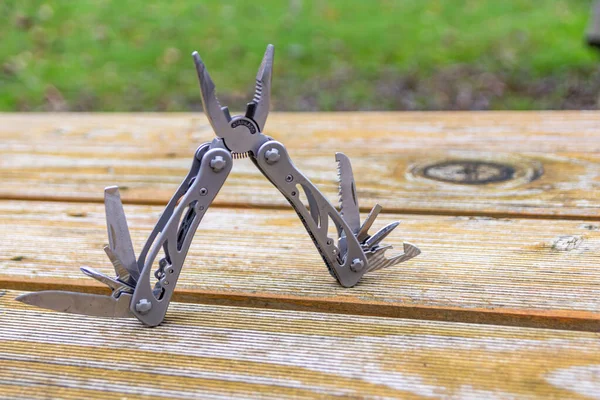 Useful multi-tool gadgets as helpful outdoor equipment for adventurers and survival experts or just camping in the wilderness with the kids and a young outdoorsman perfect with a foldable pocket knife