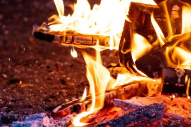 Shiny burning fire in the dark shows the romantic side of a campfire or bonfire, fire safety and the need of a fire insurance as well as survival adventures outdoor with the children and the family