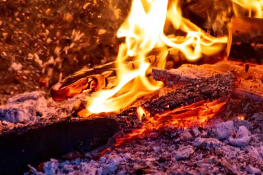 Shiny burning fire in the dark shows the romantic side of a campfire or bonfire, fire safety and the need of a fire insurance as well as survival adventures outdoor with the children and the family